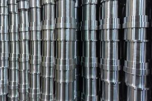 shiny steel production stack full frame background with cnc machined pipes photo