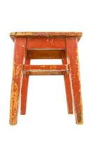 Old wooden stool with brown peeling paint. Loft style chair isolated on a white background. photo