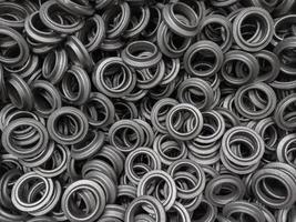 heap of grey steel ring forgings after shot blasting - close-up natural heavy industrial pattern with selective focus photo