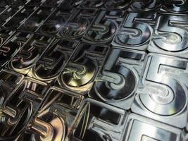 shiny metal machined digit 5 plates tiled tightly - full frame background photo