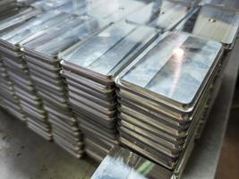 stacks of shiny metal tiles after cnc surface milling photo