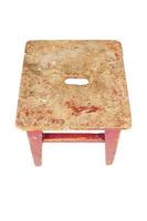 Old wooden stool with peeling red paint. Loft style chair isolated on a white background. photo