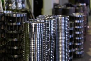 stacks of turned silver colored steel rings after cnc turning operations - close-up with selective focus photo