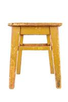 Old wooden stool with yellow peeling paint. Loft style chair isolated on a white background. photo