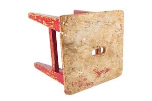 Old wooden stool with peeling red paint. Loft style chair isolated on a white background. photo