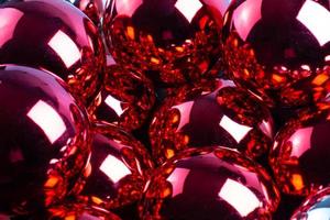 full frame background of red mirror balls close-up with selective focus photo