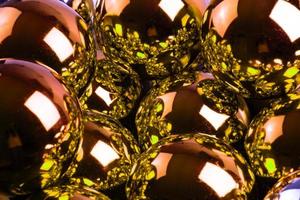 full frame background of golden mirror balls close-up with selective focus photo