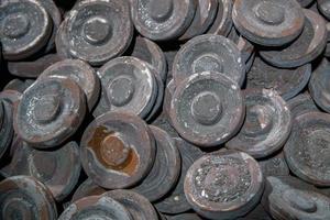 heap of grey steel round forgings - close-up natural heavy industrial pattern with selective focus photo