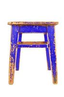 Old blue wooden stool with peeling paint. Loft style chair isolated on a white background. photo