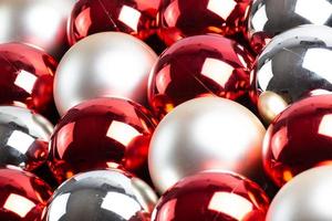 full frame background of red, silver and white mirror balls close-up with selective focus photo