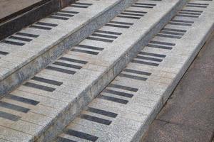 public granite stairs stylised as piano keys - close-up view photo