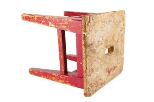 Old wooden stool with peeling red paint. Loft style chair isolated on a white background. photo