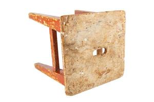 Old wooden stool with peeling brown paint. Loft style chair isolated on a white background. photo