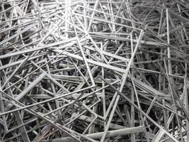 full frame abstract industrial background of stamping leftovers pile, close-up with selective focus photo