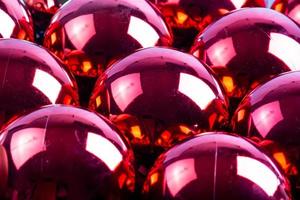 full frame background of red mirror balls close-up with selective focus photo