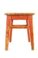 Old wooden stool with brown peeling paint. Loft style chair isolated on a white background. photo