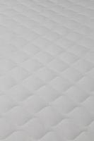 Soft white mattress close-up background with selective focus. photo