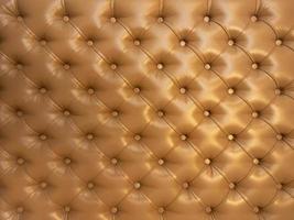 Texture of brown beige leather background with capitone pattern, full-frame. Brown retro Chesterfield style. photo