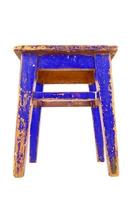 Old blue wooden stool with peeling paint. Loft style chair isolated on a white background. photo