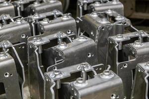 many equal welded aluminium assemblies in factory between operations photo