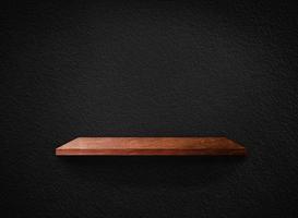 Light wood shelves on black wall texture in loft Style  background with clipping path. Design for wallpaper photo