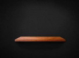 Light wood shelves on black wall texture in loft Style  background with clipping path. Design for wallpaper photo