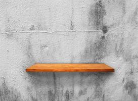 Rustic wooden shelf on grey concrete wall texture background with clipping path. pattern wallpaper photo