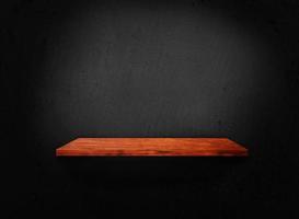 Blank of old wooden shelf on dark wall texture background with clipping path for design photo