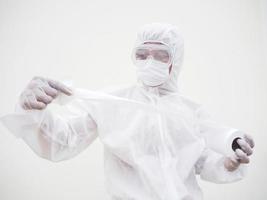 Asian male doctor or scientist in PPE suite uniform holding toilet paper. Lack of toilet paper in the quarantine of coronavirus. COVID-19 concept isolated white background photo