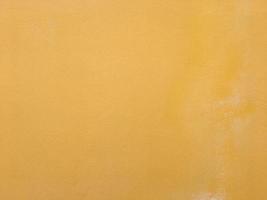 Yellow wall texture background for design with copy space photo