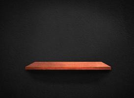 Light wood shelves on black wall texture in loft Style  background with clipping path. Design for wallpaper photo