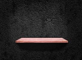 Blank of old wooden shelf on dark wall texture background with clipping path for design photo