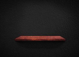 Light wood shelves on black wall texture in loft Style  background with clipping path. Design for wallpaper photo