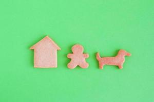 Homemade shortbread cookies on green background, top view. Man is walking with dog near house. photo