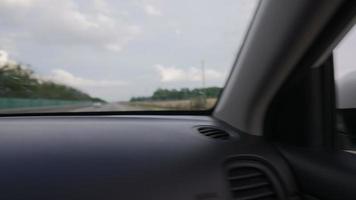 View from of the Side Mirror the Inside of a Driving Car Along the Highway in a Sunny Day. Concept of Vehicles and Transport. No People. video