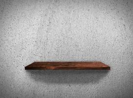 Top view of wood shelves on concrete wall texture background with clipping path for design photo