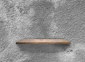 Rustic wooden shelf on grey concrete wall texture background with clipping path. pattern wallpaper photo