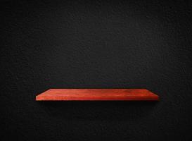 Light wood shelves on black wall texture in loft Style  background with clipping path. Design for wallpaper photo