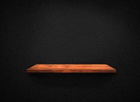 Light wood shelves on black wall texture in loft Style  background with clipping path. Design for wallpaper photo