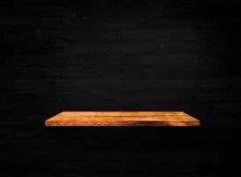 Wooden shelves on black brick wall texture background with clipping path for design photo