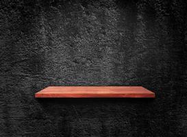 Blank of old wooden shelf on dark wall texture background with clipping path for design photo