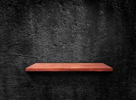 Blank of old wooden shelf on dark wall texture background with clipping path for design photo