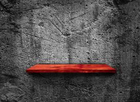 Blank of old wooden shelf on dark wall texture background with clipping path for design photo