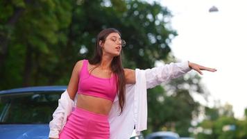 femme avec des problèmes de voiture tend la main pour héler une voiture pour obtenir de l'aide video