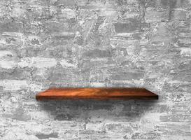 Rustic wooden shelf on grey concrete wall texture background with clipping path. pattern wallpaper photo