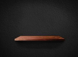 Light wood shelves on black wall texture in loft Style  background with clipping path. Design for wallpaper photo