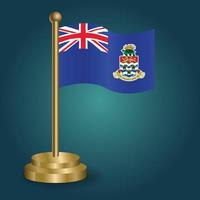 Cayman Islands national flag on golden pole on gradation isolated dark background. table flag, vector illustration