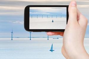 tourist taking photo of Middelgrunden wind farm