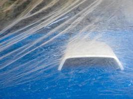 The Blue car with white vent air scoop That was covered with plastic to prevent dust photo