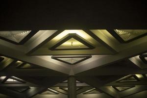 Light triangle. Lamp on ceiling. Light design. Architecture of 20th century. photo